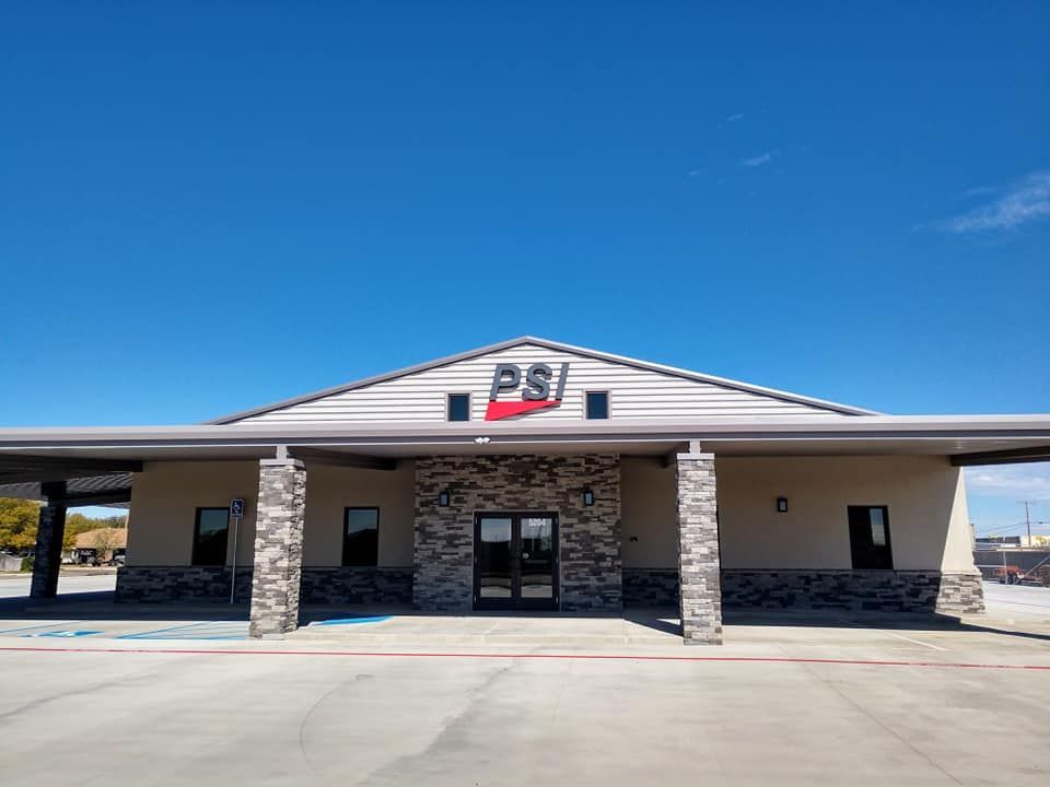 Exterior of a PSI building under a clear blue sky. 