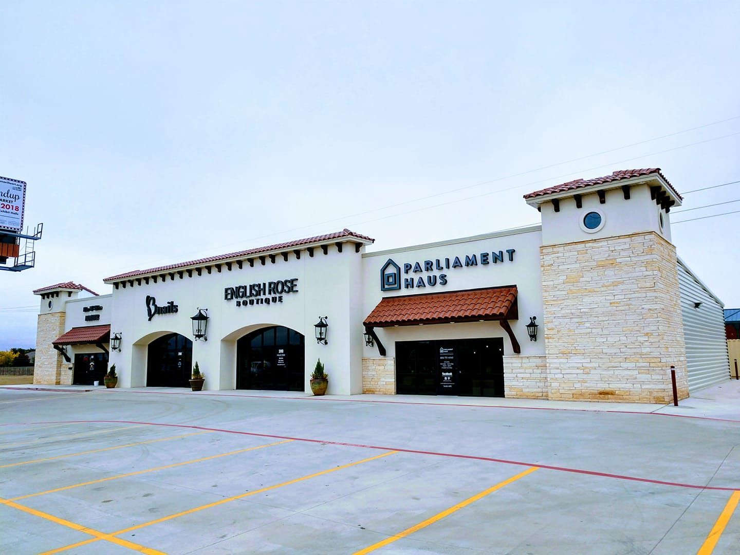 Exterior view of a shopping center with businesses.
