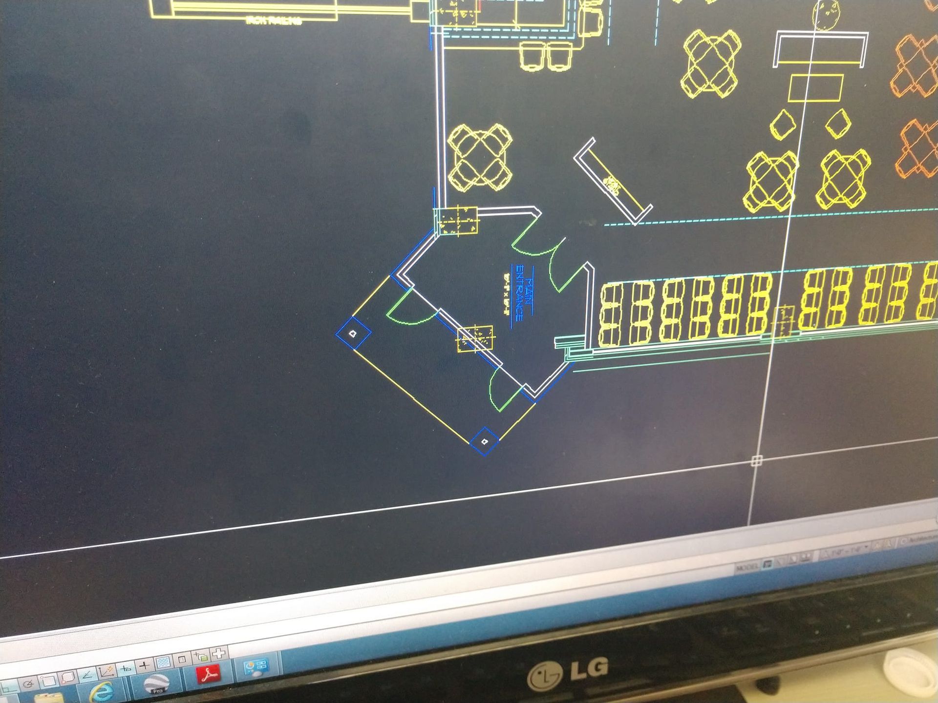 Floor plan on a computer screen, with yellow and blue line drawings of furniture and rooms in a building.
