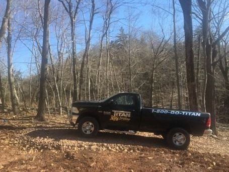 Black pickup truck in a forest setting, with