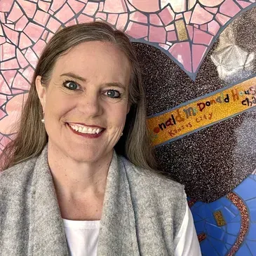 Smiling woman standing before a 