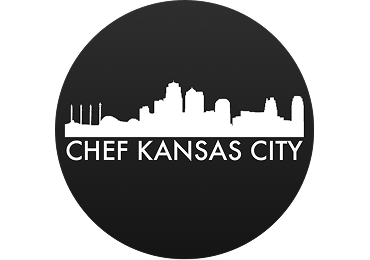 A circular logo featuring a white Kansas City skyline silhouette above the white text 