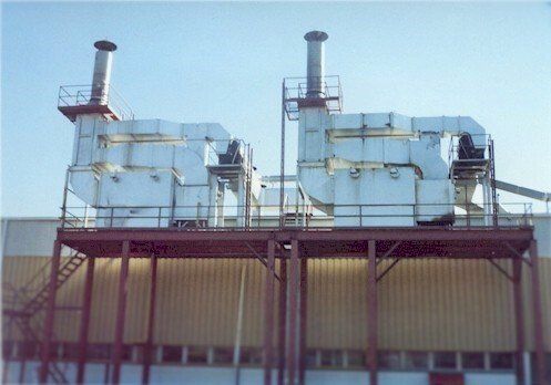 A building with a lot of pipes on top of it