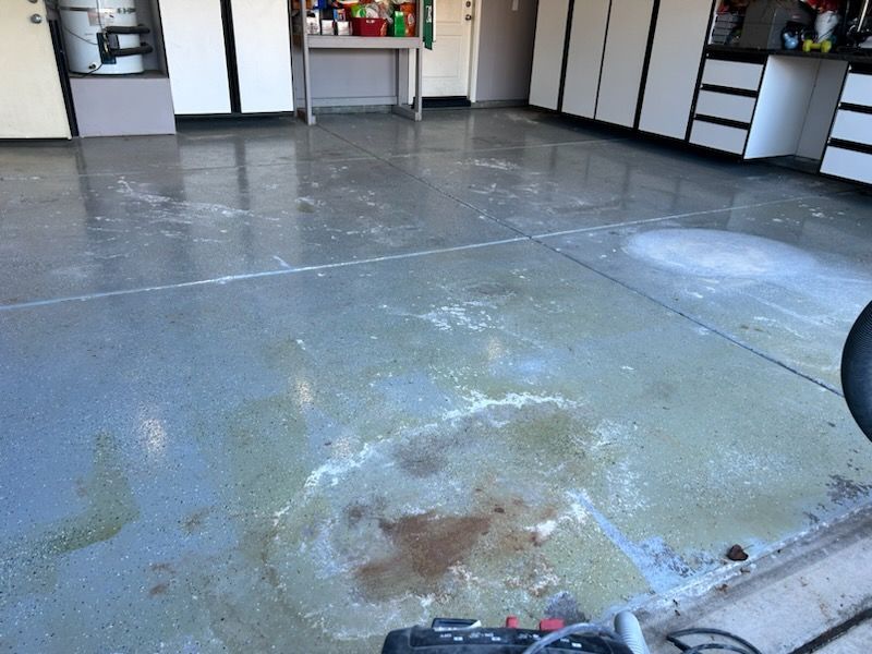 A concrete floor in a garage with a stain on it