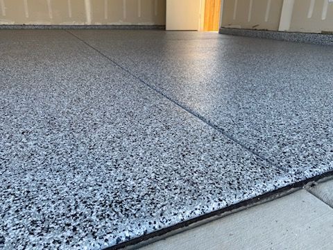 A close up of a gray concrete floor in a garage.