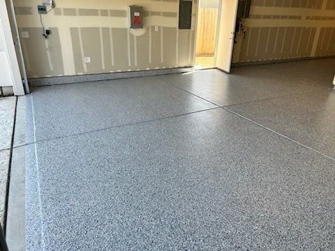 A garage with a gray floor and white walls.