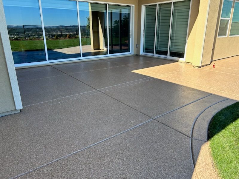 A patio with a lot of windows and a sliding glass door.