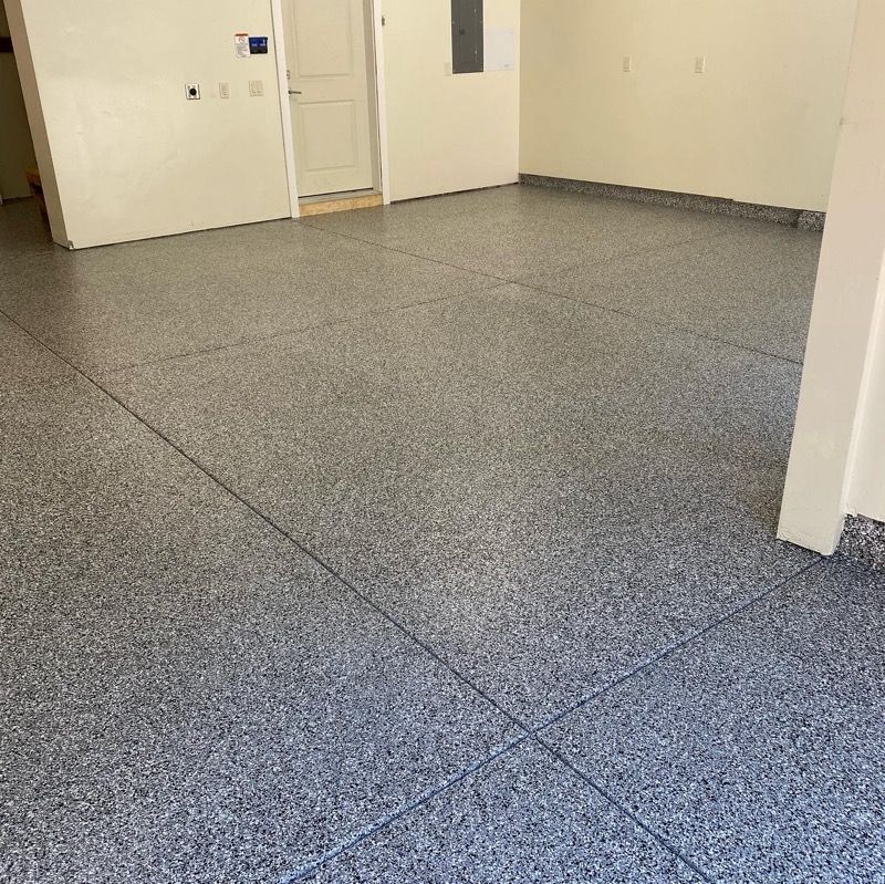 A room with a gray floor and white walls.