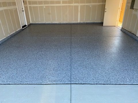 A garage with a concrete floor and a door.