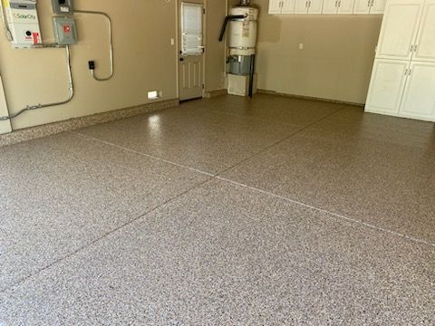 A garage with a concrete floor and a water heater.