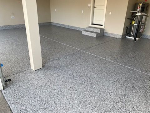 A garage with a concrete floor and a door.