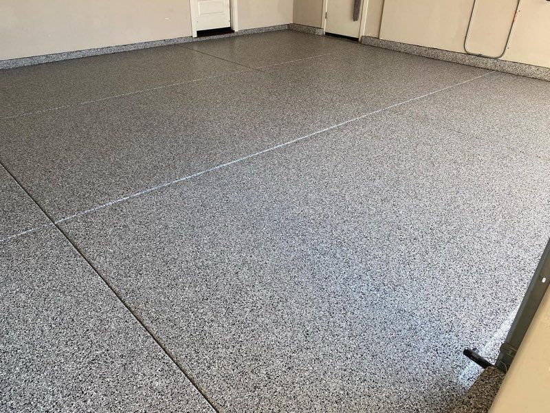 A close up of a gray concrete floor in a garage.