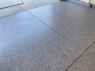 A close up of a gray concrete floor in a garage.