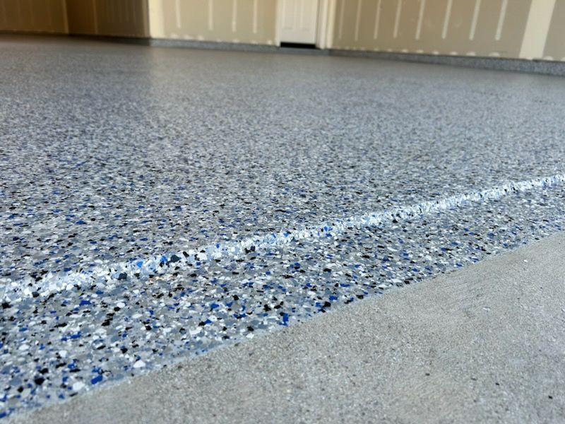 A close up of a garage floor with a white line on it.
