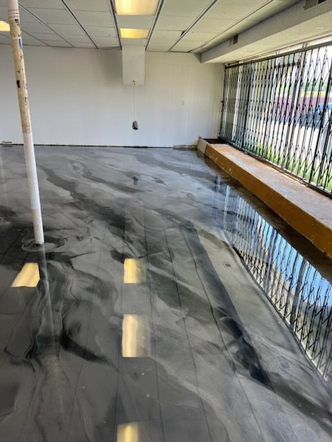 A room with a metallic floor and a window.