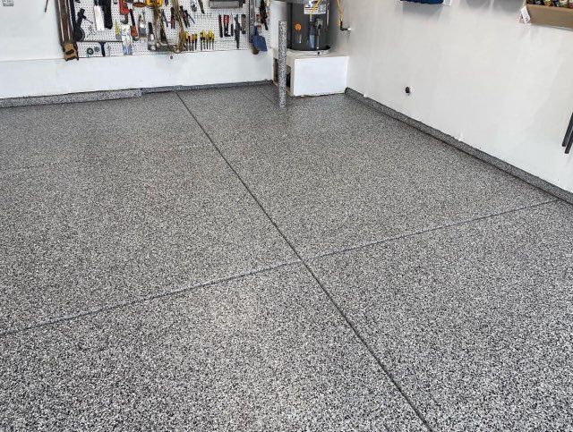 A garage with a gray floor and white walls.