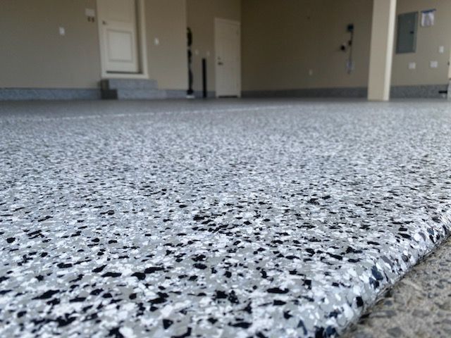 A close up of a black and white floor in a garage.