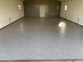 A garage with a concrete floor and a door.