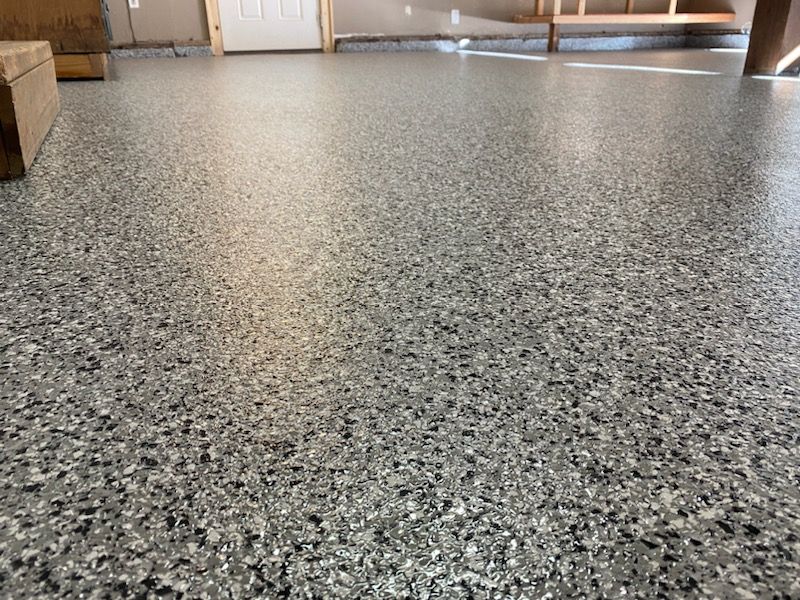 A close up of a gray concrete floor in a garage.