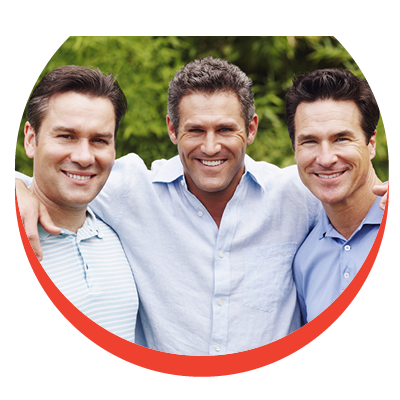 Three casually dressed men with fine hair cuts standing closely together with big smiles staring into the camera