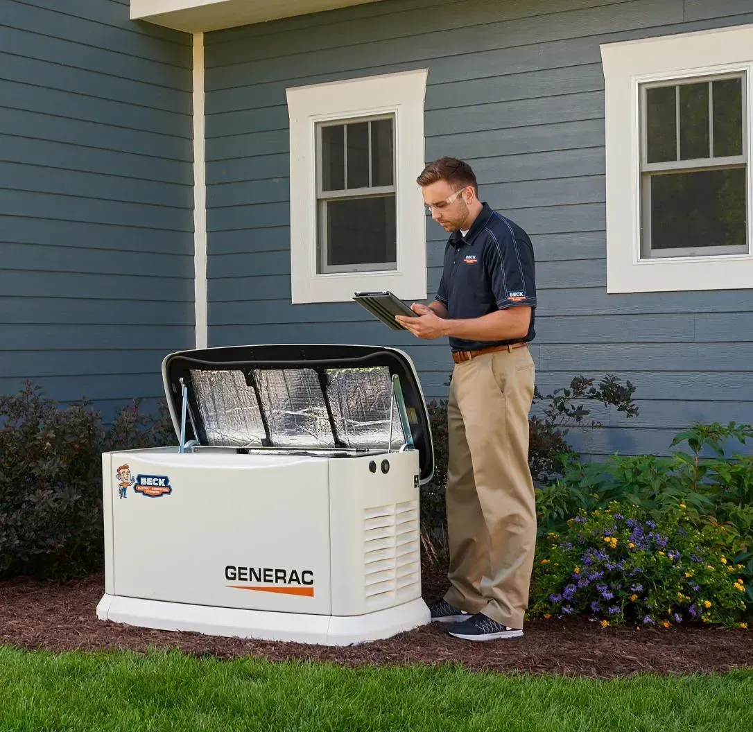 Technician inspecting a Generac home generator beside a blue house