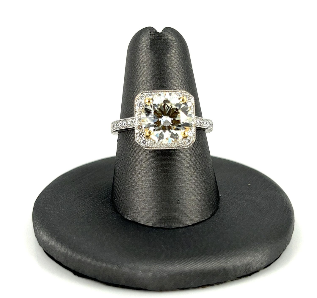 A diamond ring is sitting on a black ring holder
