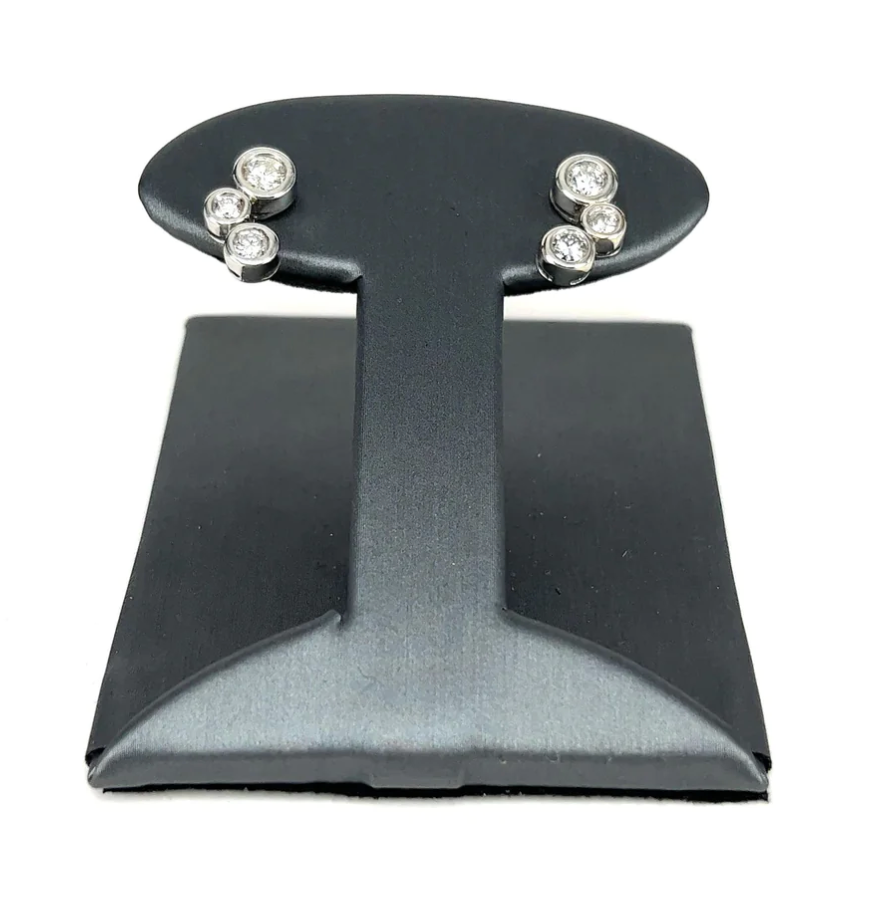 A pair of earrings on a black display stand