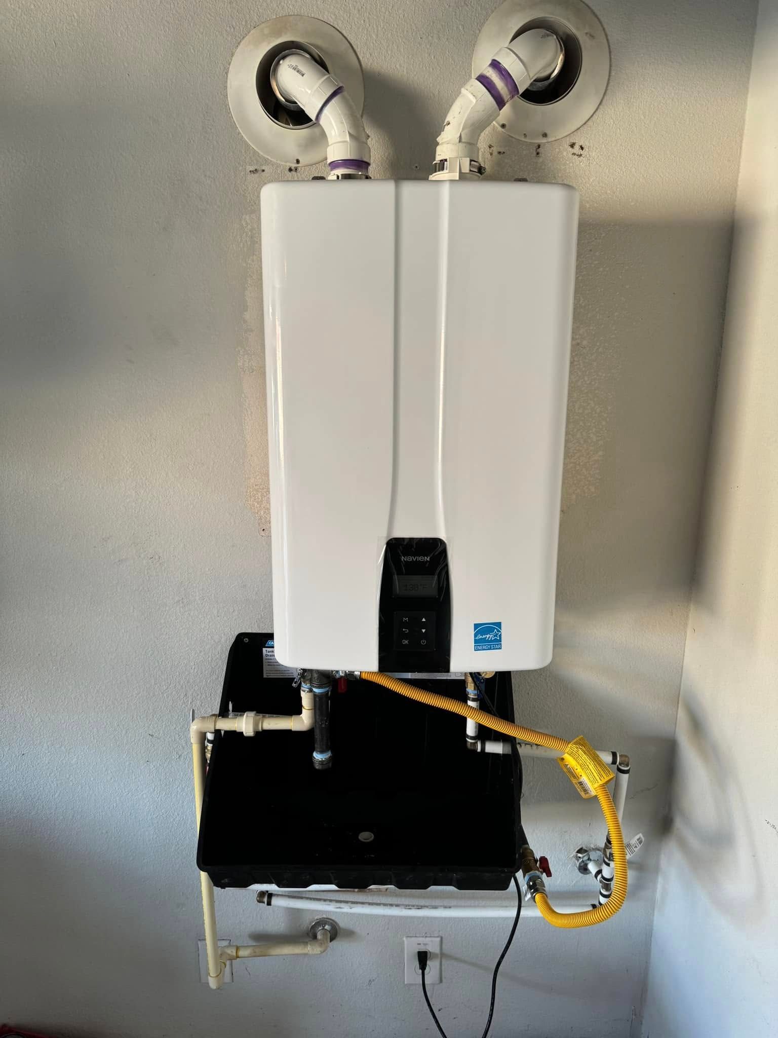 A white water heater is hanging from the ceiling in a room.