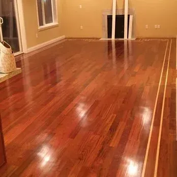 A living room with hardwood floors and a fireplace.