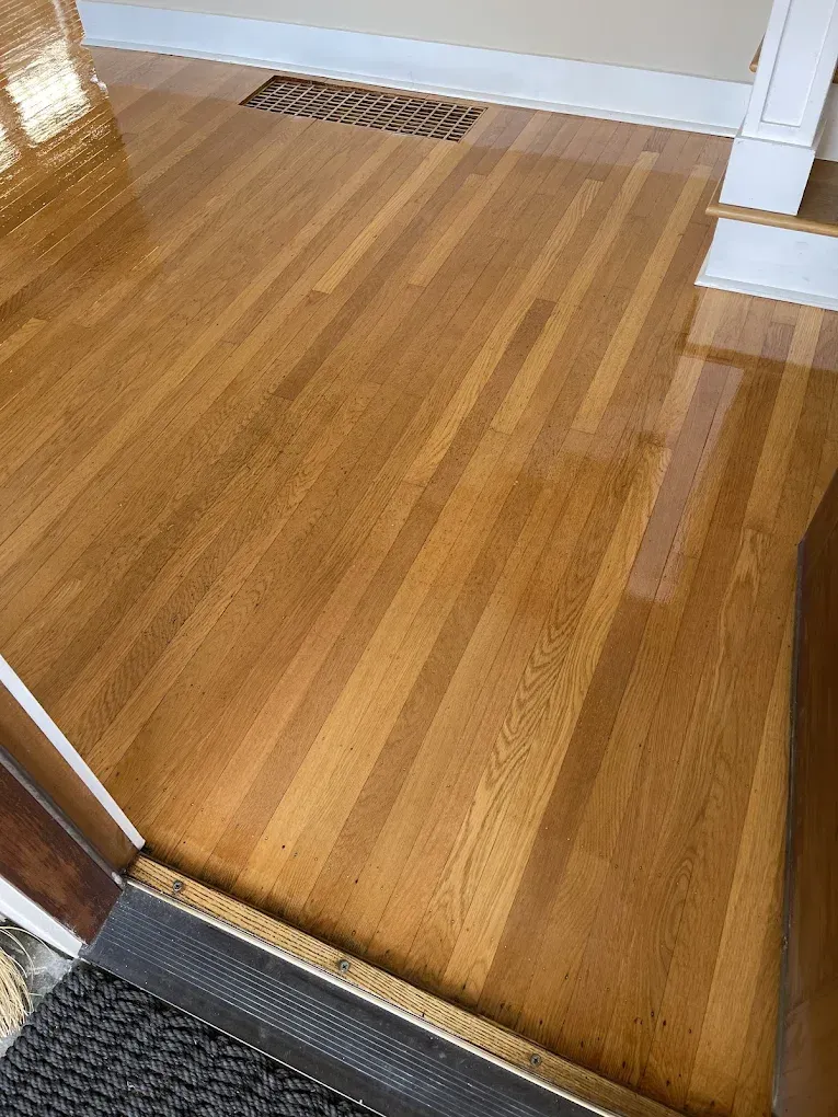 A close up of a wooden floor in a room.
