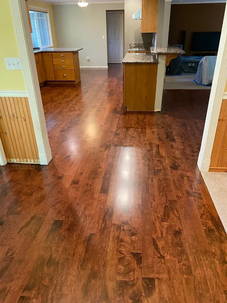 A kitchen with hardwood floors in a house.