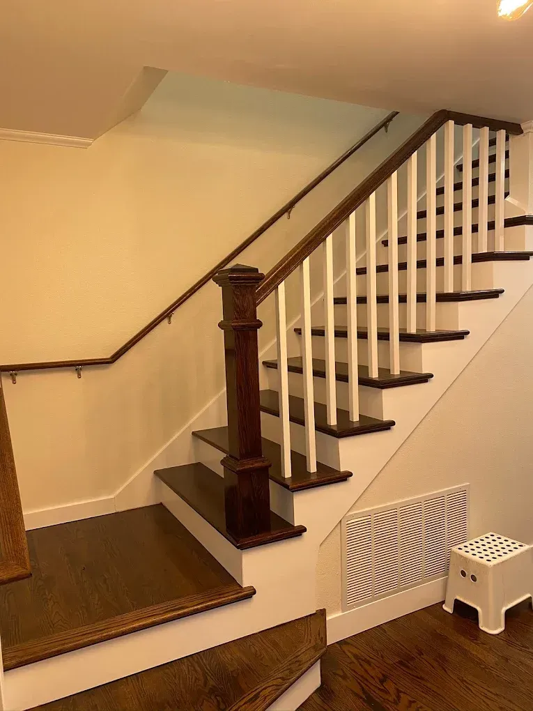 A staircase with wooden steps and a white railing