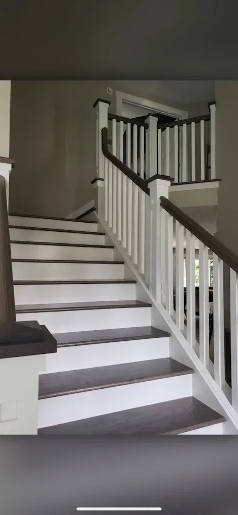 A staircase with a white railing and wooden steps in a house.