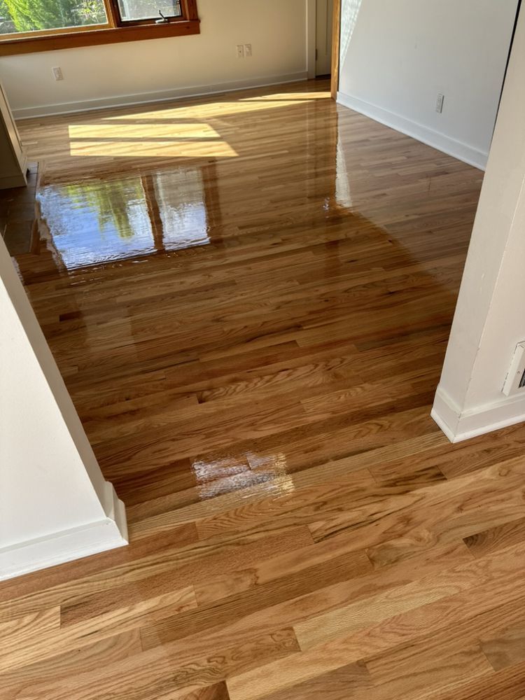 A living room with hardwood floors and a window.