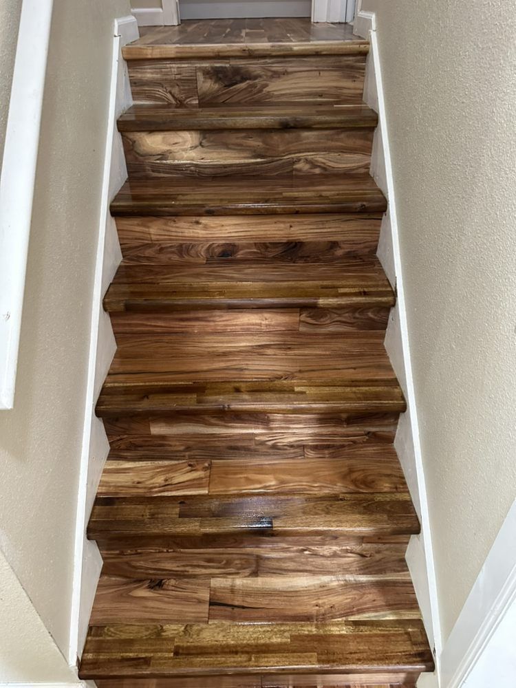 The stairs are made of wood and have a white railing.