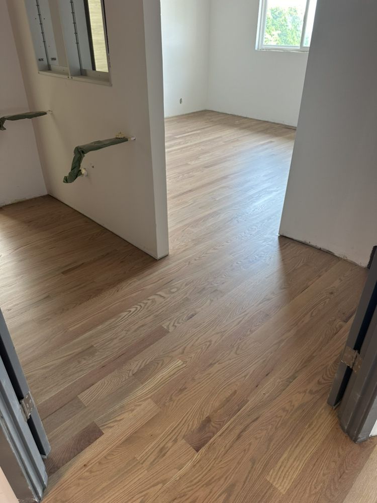 A room with a wooden floor and white walls.