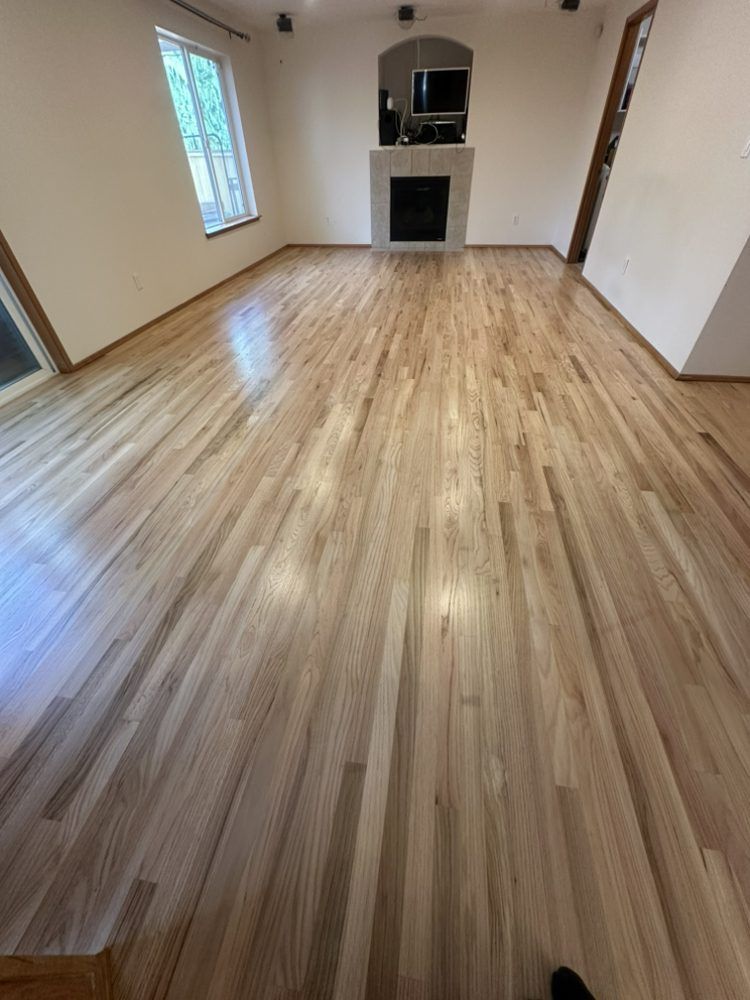 A living room with hardwood floors and a fireplace