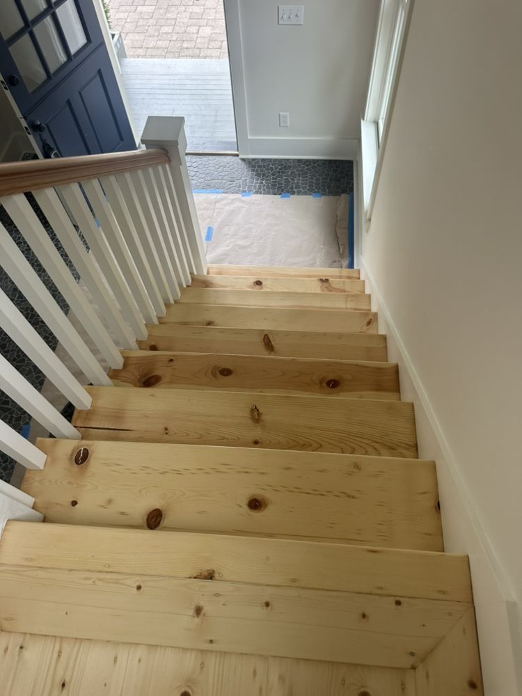 The stairs are made of wood and have a white railing.