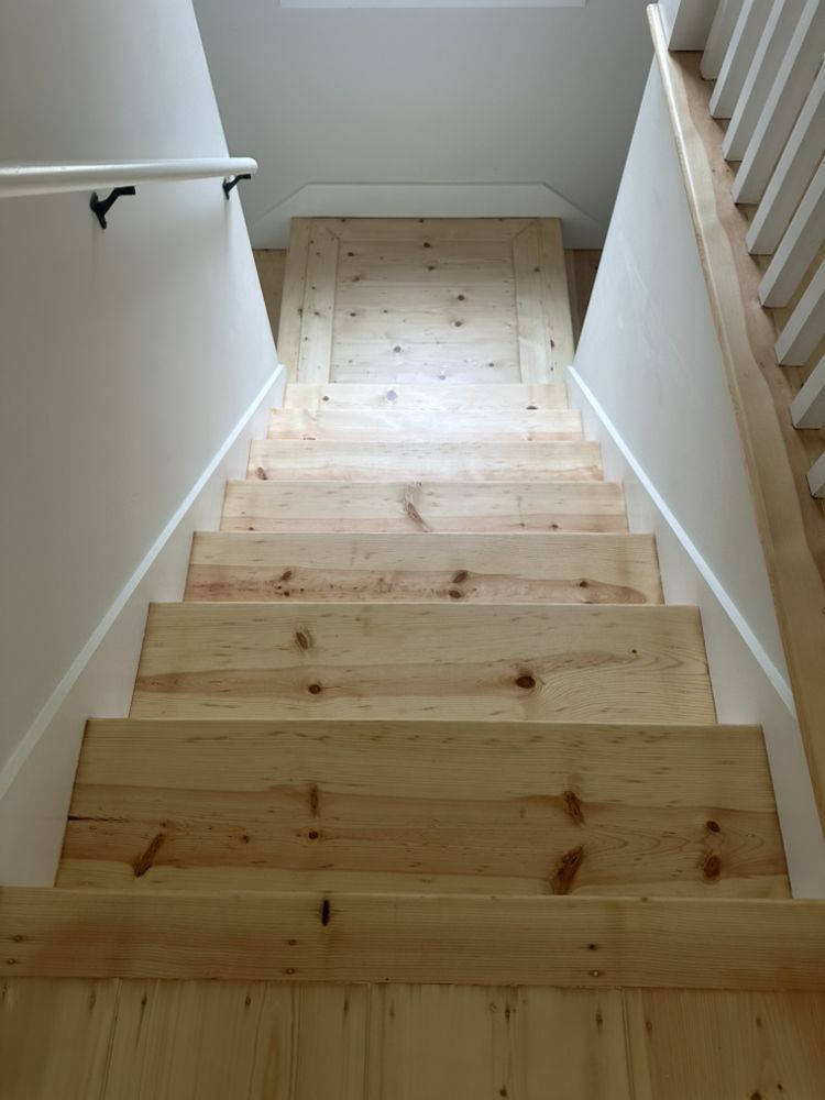 A set of wooden stairs leading up to a second floor