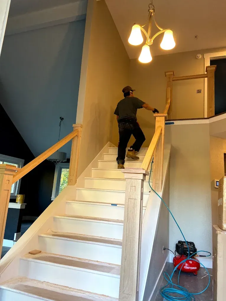 A man is standing on top of a set of stairs.