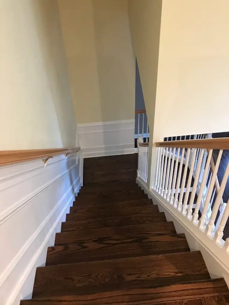 A set of wooden stairs leading up to a second floor in a house.