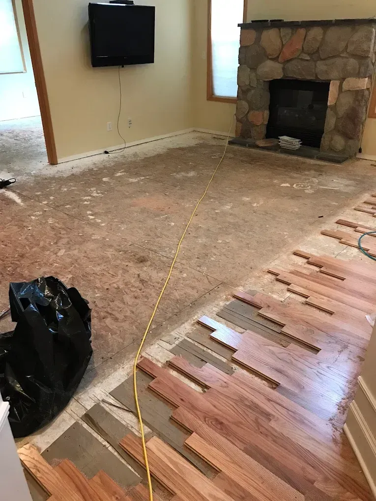 A living room with hardwood floors and a fireplace.