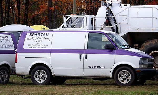 White van with a purple stripe and the logo 