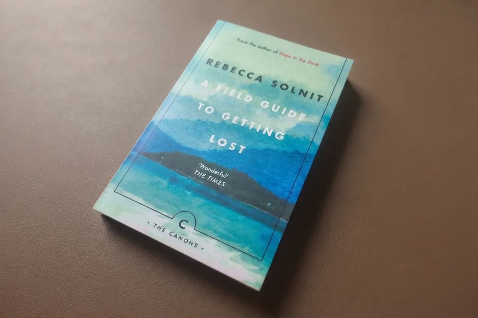 A close-up, high-angle shot of the book A Field Guide to Getting Lost by Rebecca Solnit, centered on