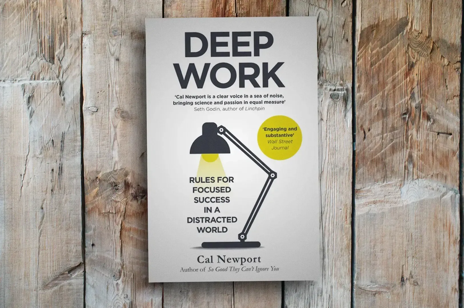 Straight-on eye-level shot of the book cover “Deep Work” by Cal Newport, showing minimalist typograp