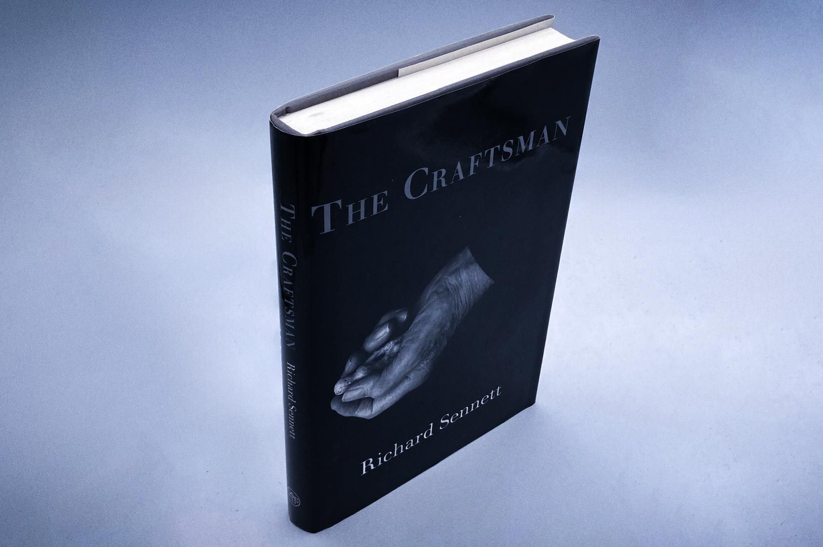 Hardcover book titled The Craftsman by Richard Sennett, shown standing upright with a black cover fe