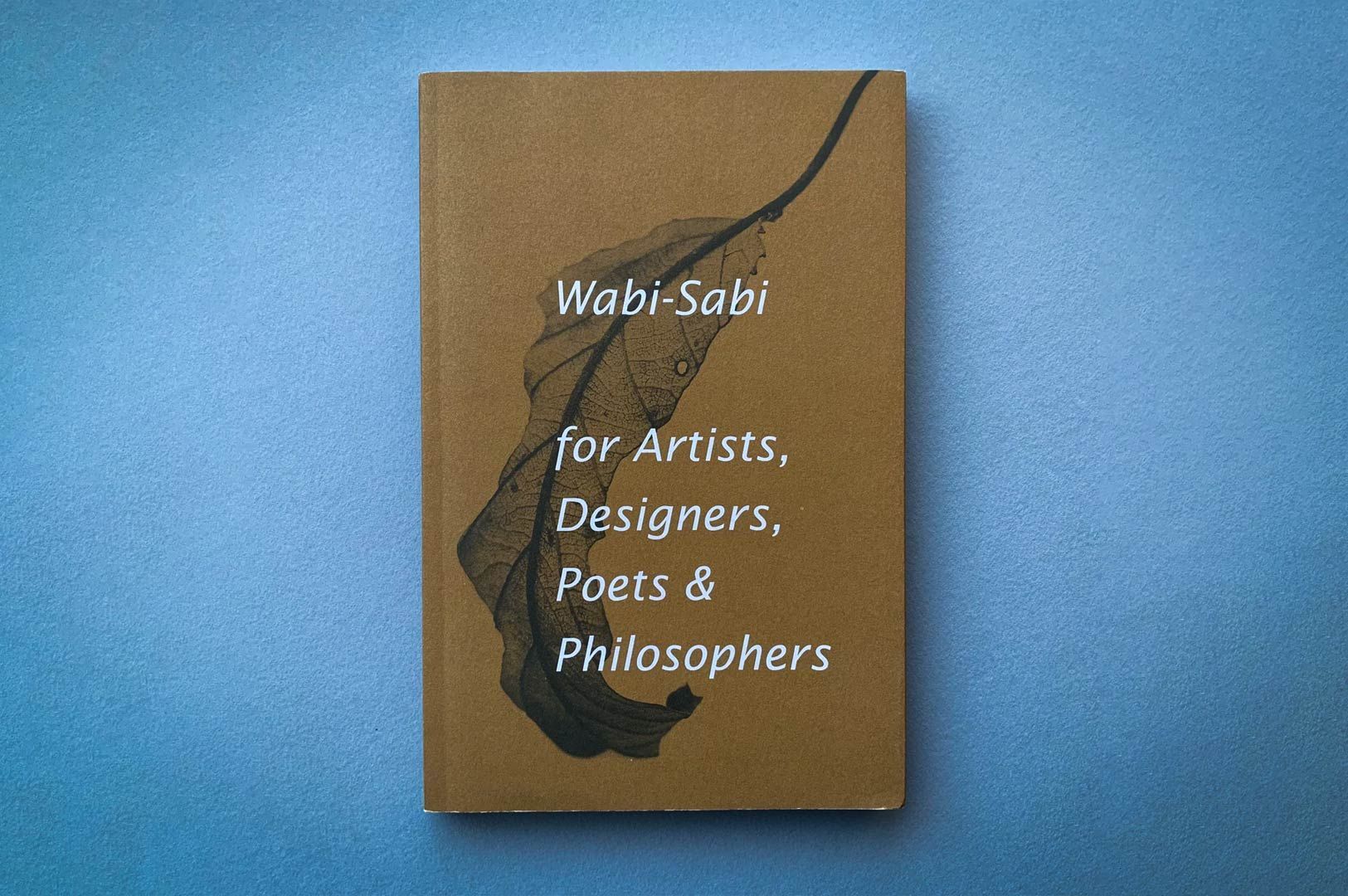 Book titled ‘Wabi-Sabi for Artists, Designers, Poets & Philosophers’ on a blue background, featuring