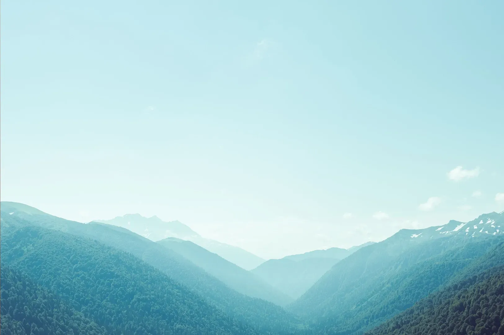 A panoramic view of misty, layered mountain ranges, visually representing the concepts of uncertainty and discovery found in Rebecca Solnit’s A Field Guide to Getting Lost.