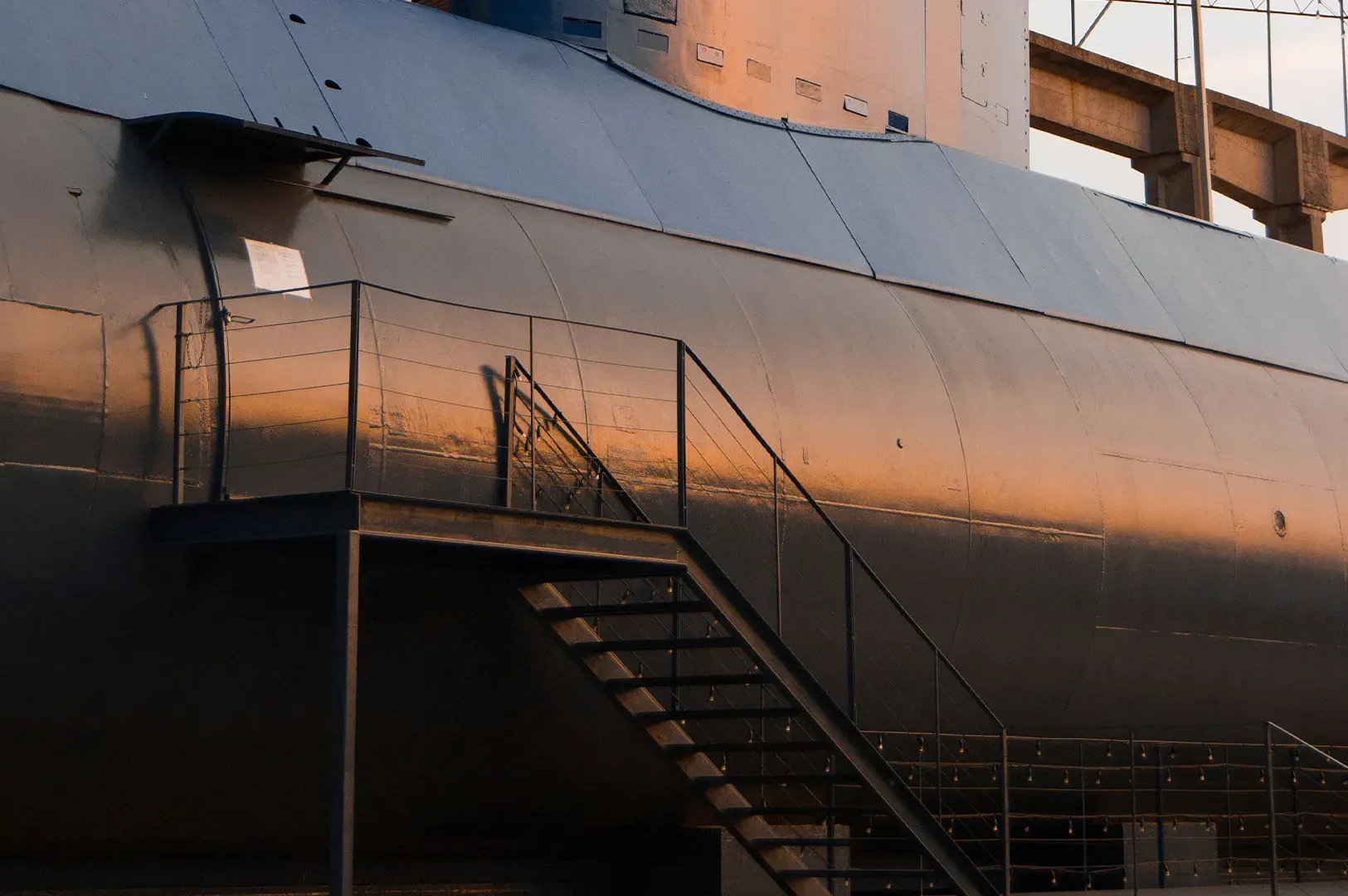 A metal staircase leading up to a submarine hull, representing the high-stakes environment of L. David Marquet’s