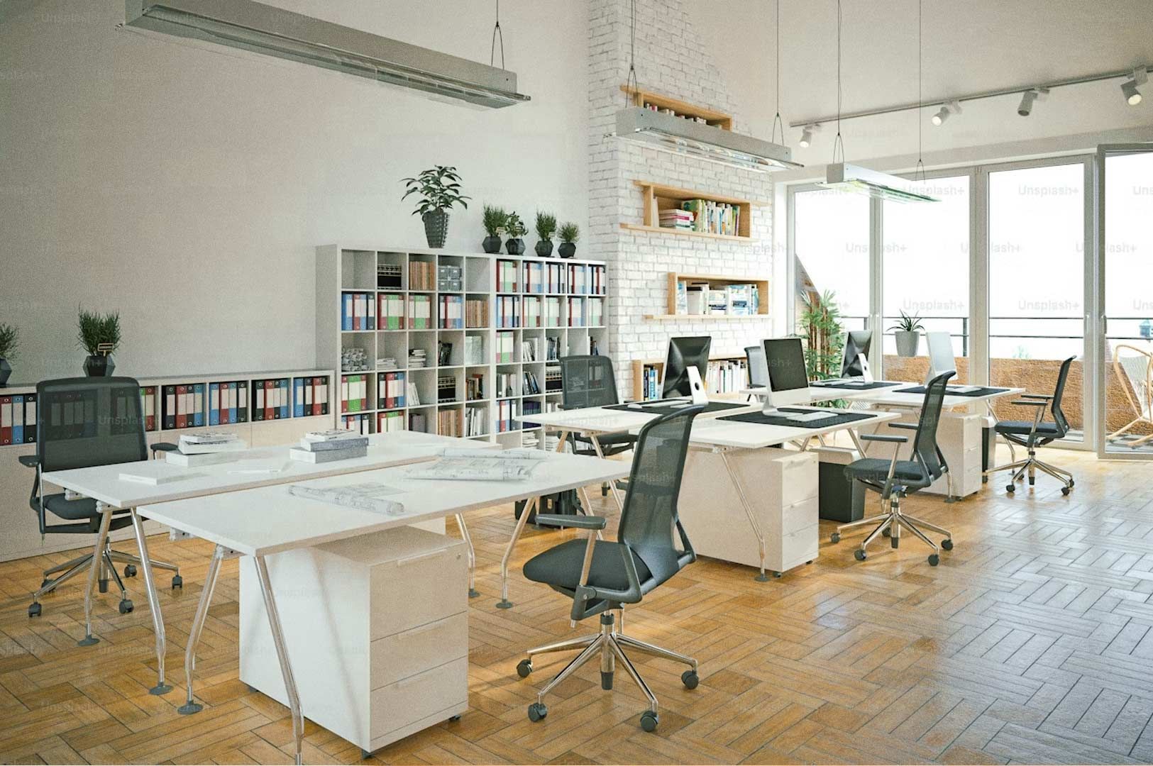 Bright modern office interior featuring white desks, ergonomic chairs, shelving with organized binders, large windows, and natural light.
